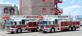 Two Seagrave apparatus, parked side by side.